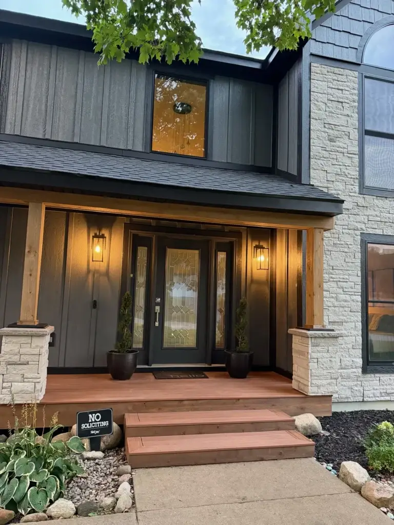 After: front entry at dusk with glowing lanterns and stone piers
