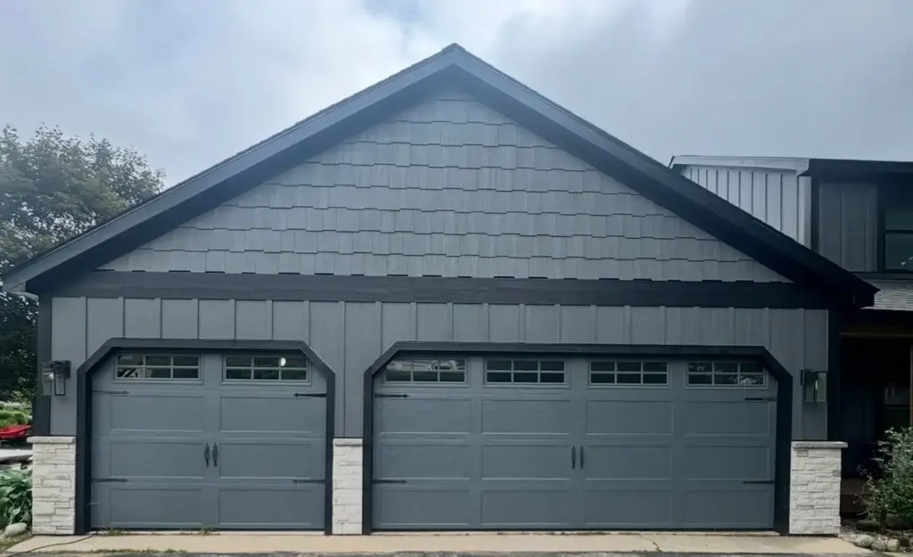 After: garage with charcoal doors, shake siding and lantern sconces