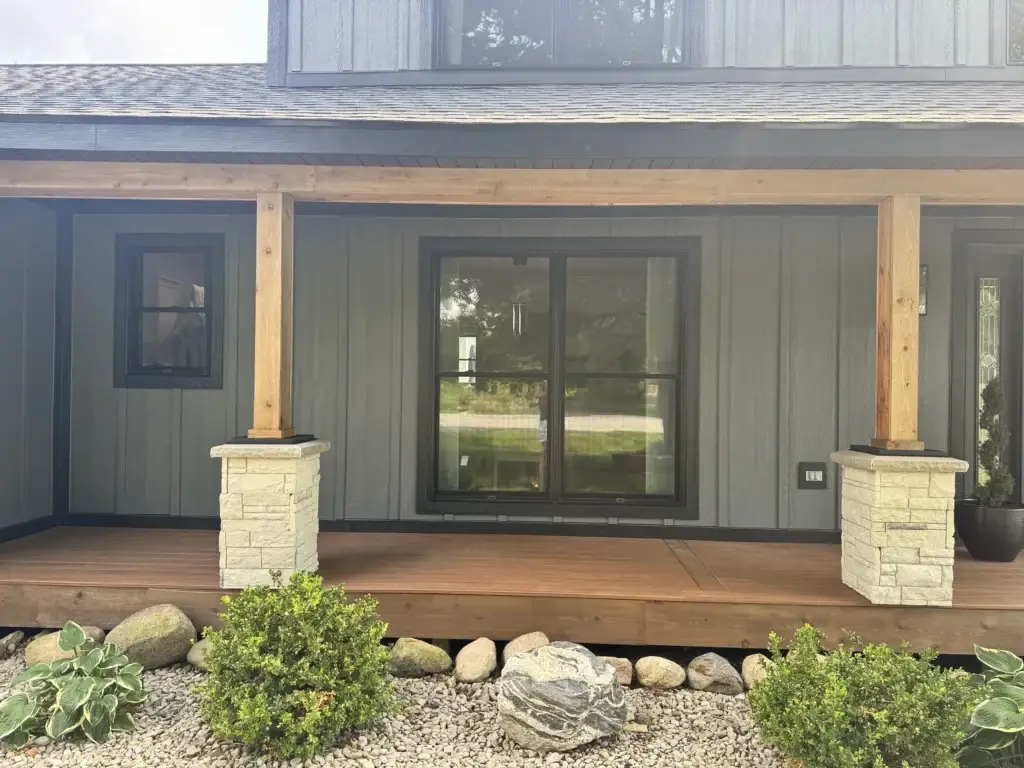 After: porch detail with cedar posts, stone piers and black-framed slider
